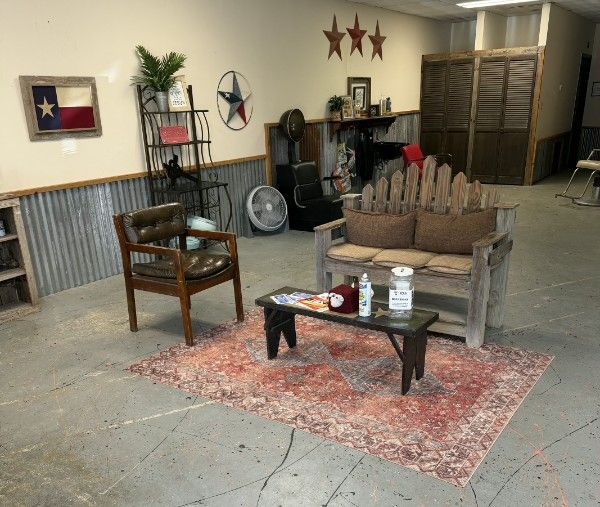 Cozy rustic waiting area with leather chairs and a Texas star
