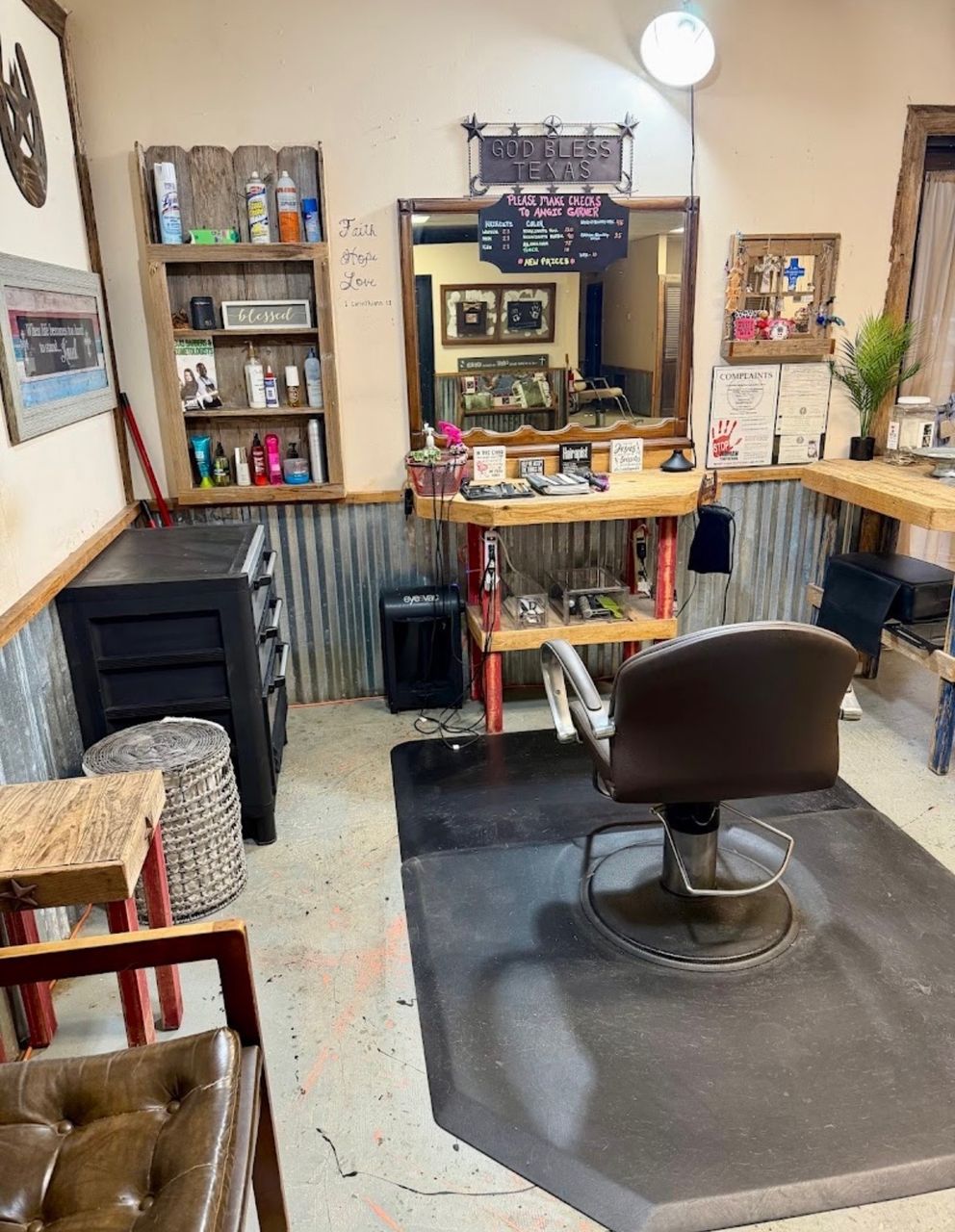 Inside Texas Hair Shoppe — styling chair beneath the God Bless Texas sign